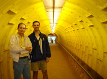 Two people standing in a tunnel